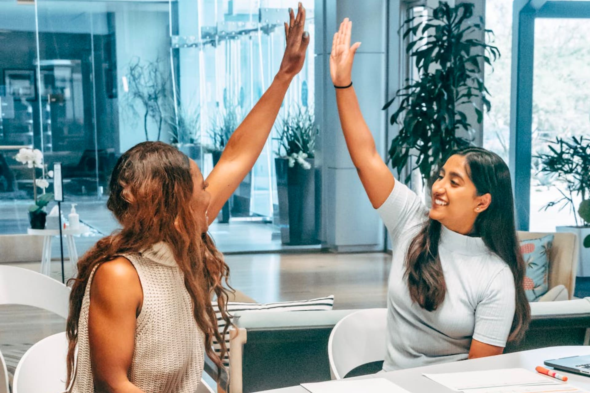 two partners high fiving each other for new joint venture