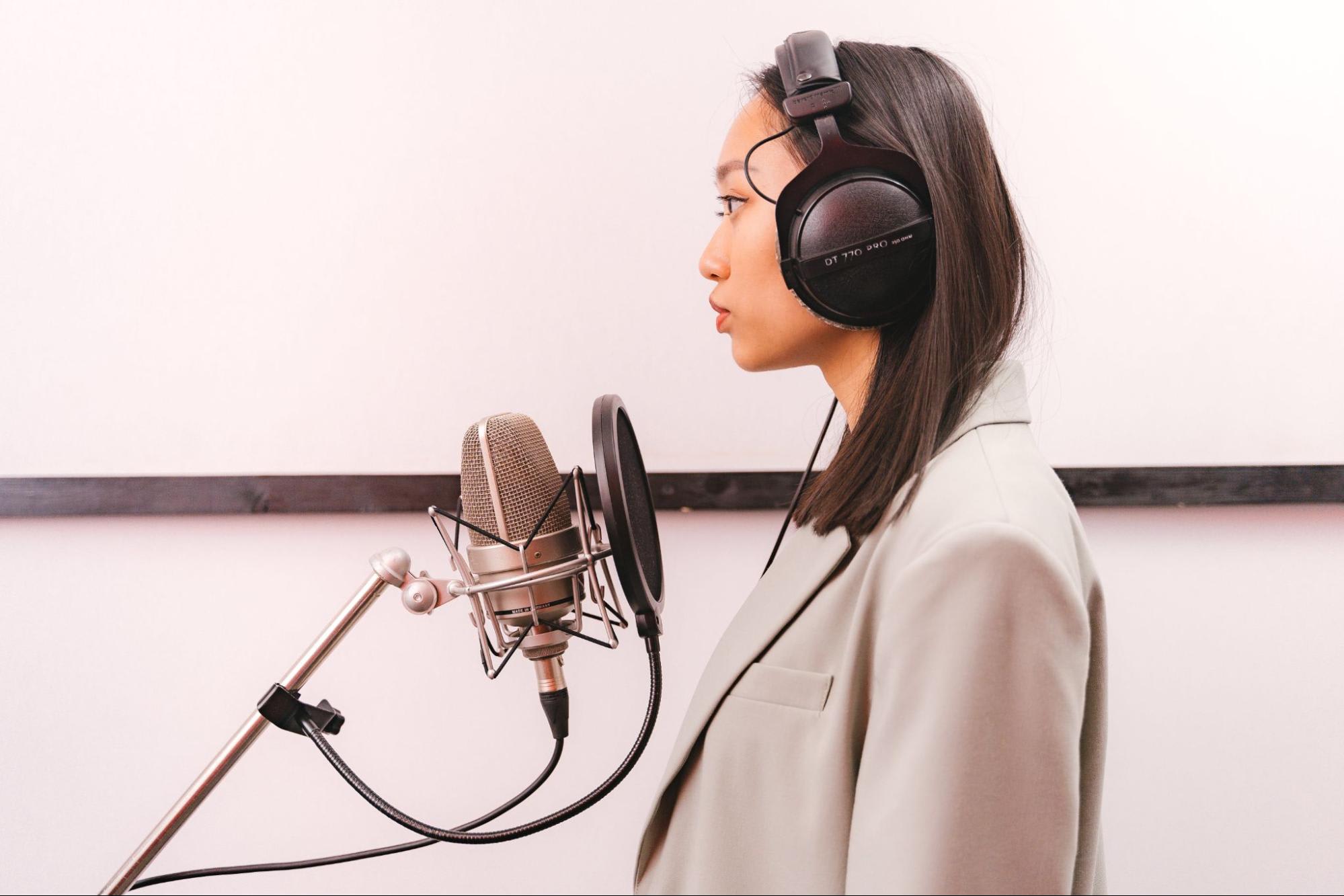 A woman recording voiceover in studio. Antoni Shkraba for Pexels.