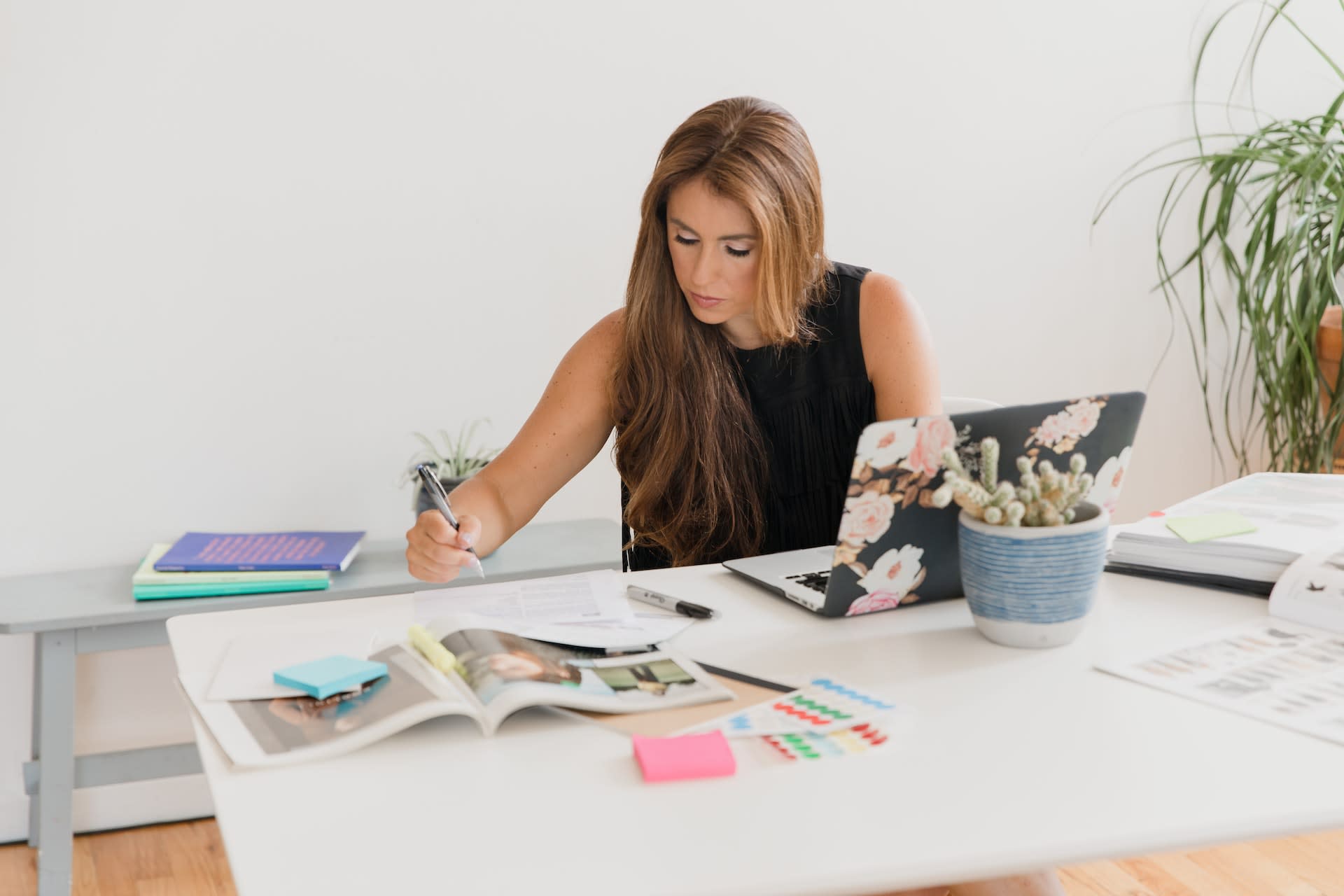 woman sitting at laptop writing proposal