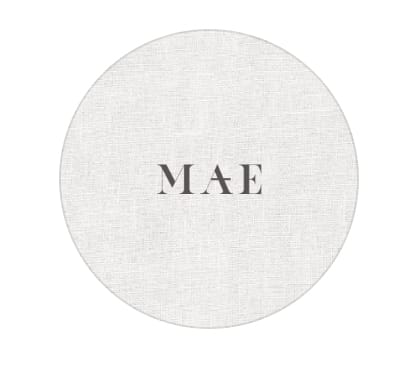 Simple circular logo with 'MAE' text in a serif font on a light textured background.