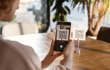 Woman holding phone scanning a QR Code