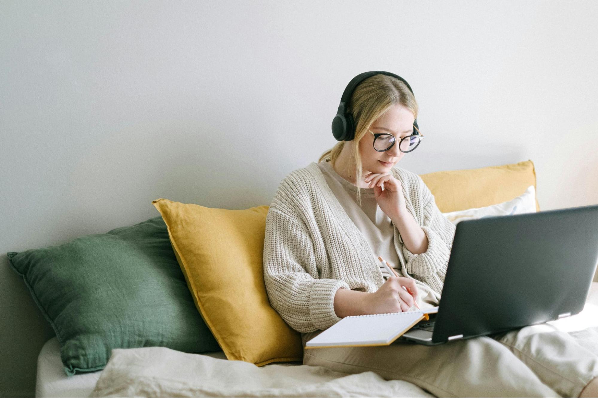 Photos of a woman taking notes on unmarked laptop