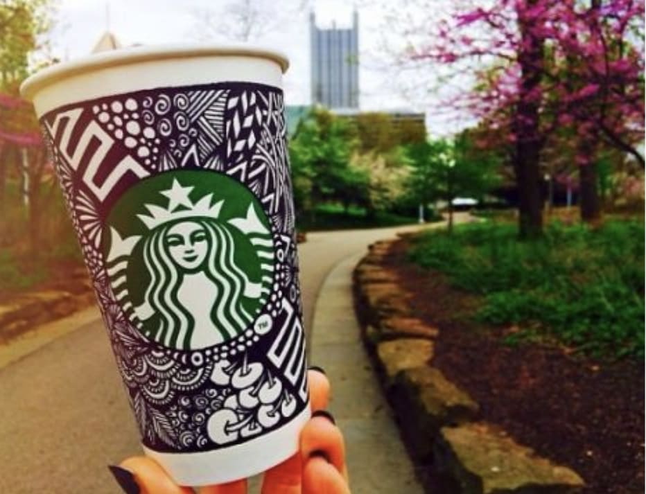 Woman holding Starbucks white coffee cup decorated with black ink, #WhiteCupContest, 2014