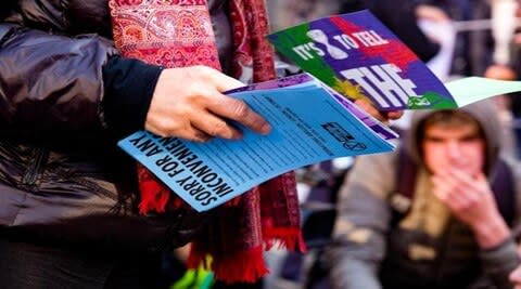 Person holding a few magazines