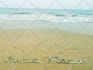 write your text on sand with natural shells and beach stones