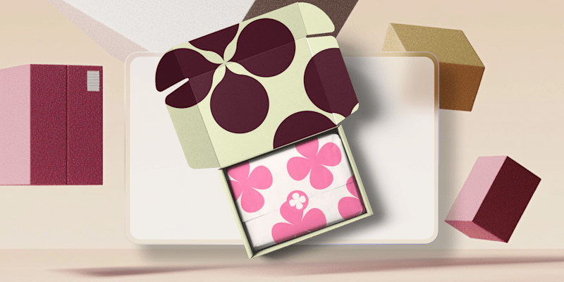 decorative open box with pink and floral patterns against a neutral backdrop, showcasing packaging design