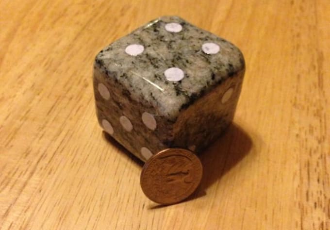 hand sculpt a large dice out of real stone