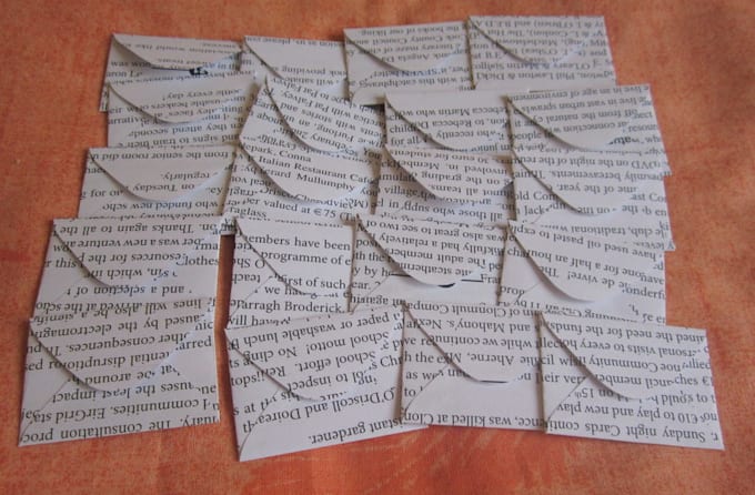 make 25 tiny envelopes from recycled newsletter pages