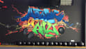 paint real graffiti art on the street wall
