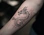 create a small, minimalistic, fine line spiritual tattoo
