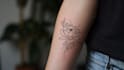 create a minimalist fine line tattoo design