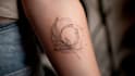 create a minimalist fine line tattoo design