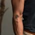 create a small minimalistic fine line spiritual tattoo