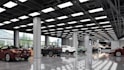 create a luxury 3d car dealership or auto showroom interior and exterior render