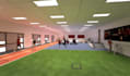 design a realistic 3d football academy with training fields, dorms, and plan