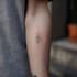 create a small, minimalistic, fine line spiritual tattoo