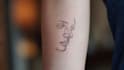 create a minimalist fine line tattoo design