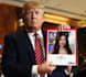 make donald trump hold your photo or logo with your text