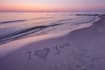 create custom sandwriting ai art on a beautiful beach