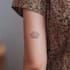create a small, minimalistic, fine line spiritual tattoo