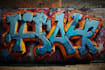 paint real graffiti art on the street wall