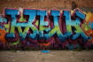 paint real graffiti art on the street wall