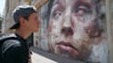paint real graffiti art on the street wall