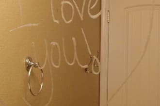 wirte a love note in lipstick on a mirror take a picture and send it to you