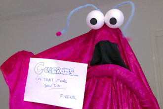 take photos dressed as a Sesame Street Yip Yip with a sign