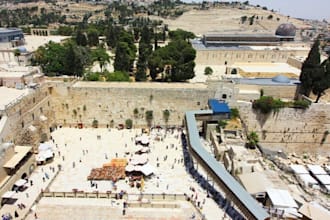 placing a prayer note at the western wall in jerusalem