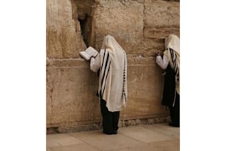 placing a prayer note between the stones of the western wall kotel