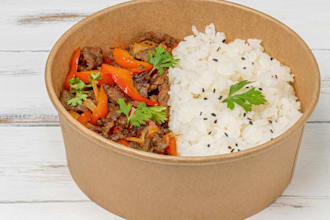 make cooked meat with red pepper in brown paper bowl
