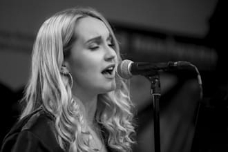 sing soft acoustic folk and indie pop songs as a female vocalist