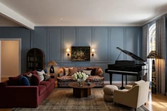 design a cozy transitional living room with furniture and lighting
