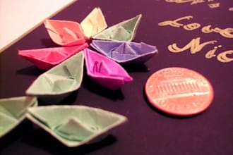 write your name with miniature paper boats