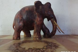 create the wooden statues of elephants