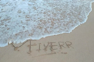 write your message creatively on a beach as  video or photo