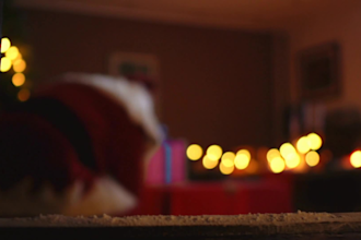 create a video of santa claus placing a christmas present with your logo tag