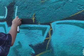 paint real graffiti art on the street wall