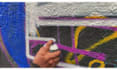 paint real graffiti art on the street wall