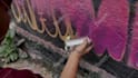 paint real graffiti art on the street wall