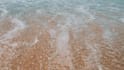 write your message creatively on a beach as  video or photo