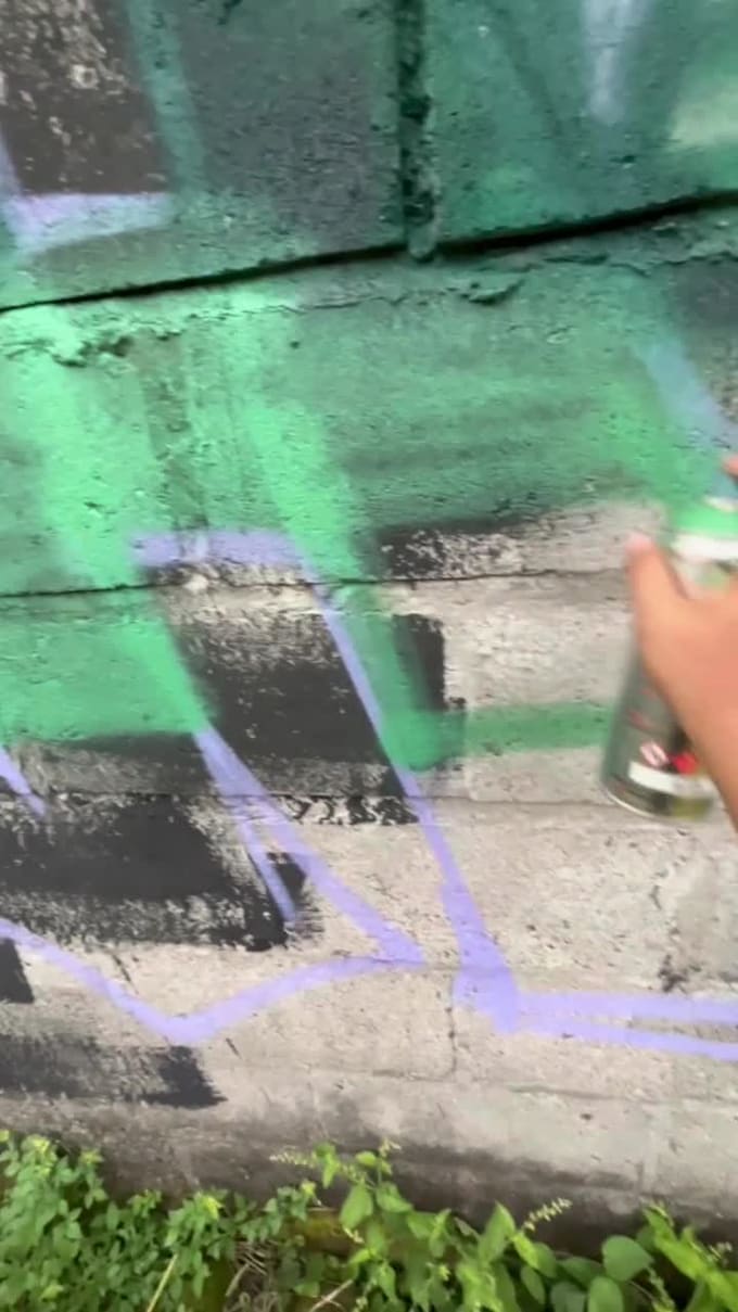 make real graffiti and mural on the street wall