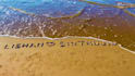 write your message using colorful stones in the beach