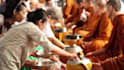offer food or alms to the buddhist monk on your behalf